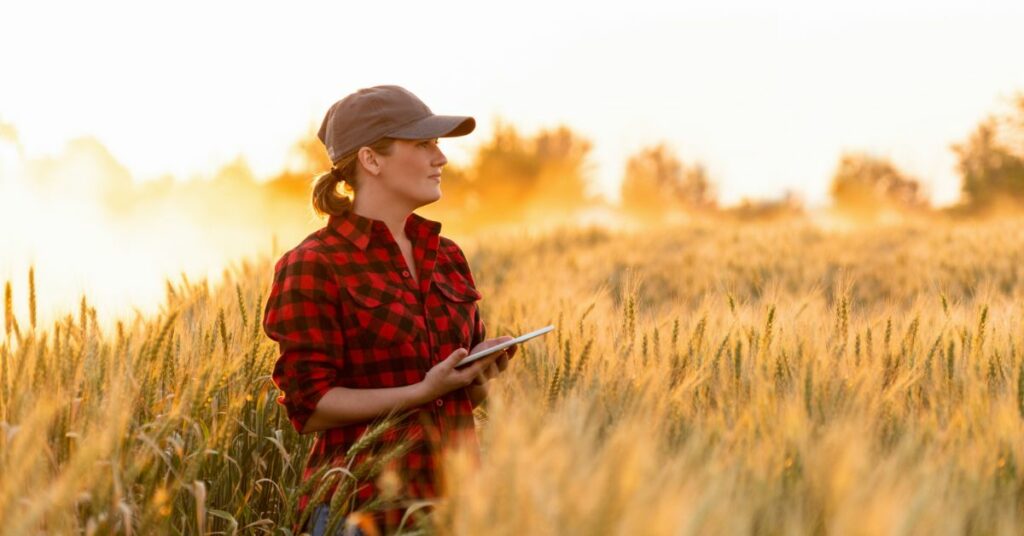 rural woman on tablet in field